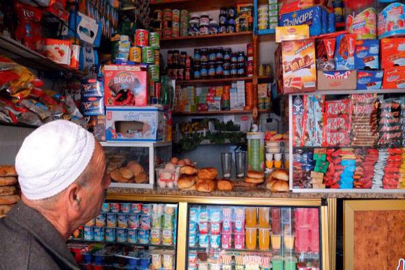 Why do informal businesses set shop next to each other in Morocco?