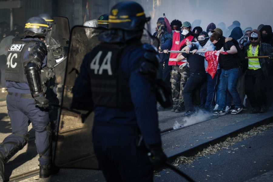 Police fire tear gas as thousands march in France